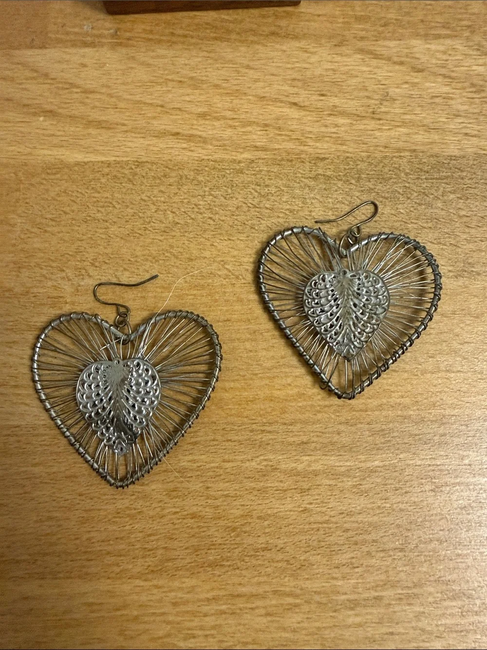 Large dangle silver tone heart earrings striated statement wire